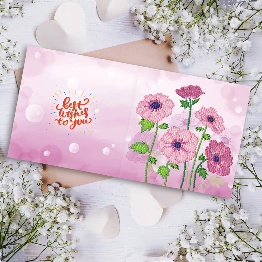Diamond painting wenskaart met de tekst 'Best wishes to you' en roze bloemen tegen een roze achtergrond