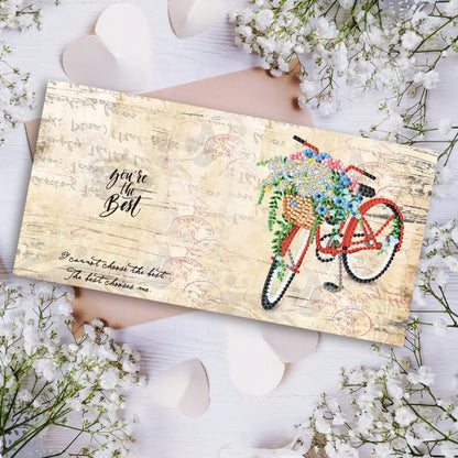 Diamond painting wenskaart met de tekst 'You're the best' en een rode fiets met bloemenmand tegen een vintage achtergrond.